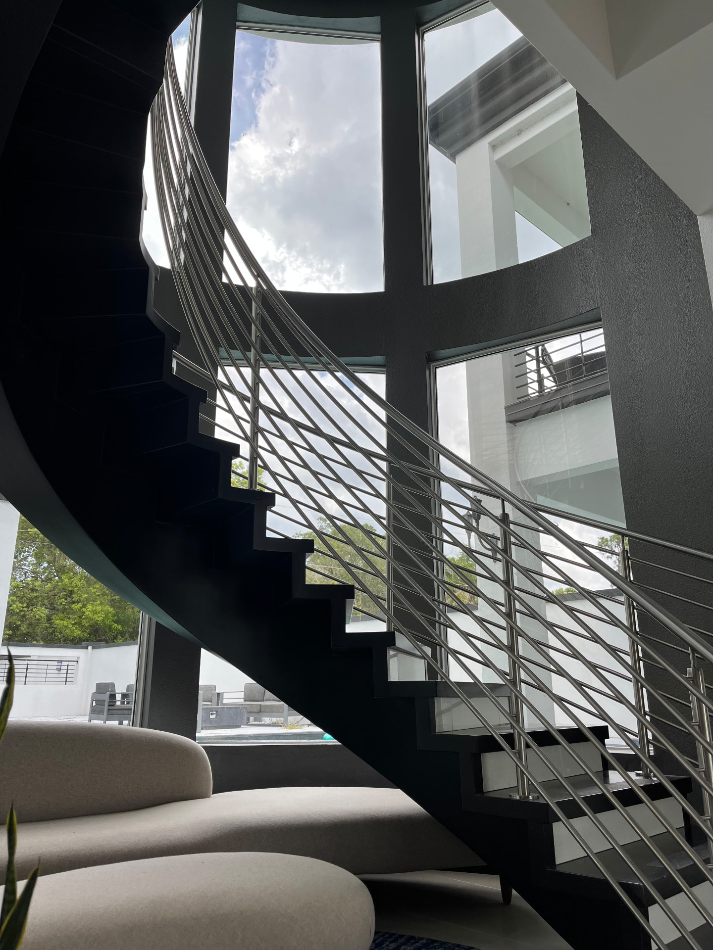 Interior spiral staircase with floor-to-ceiling tinted glass