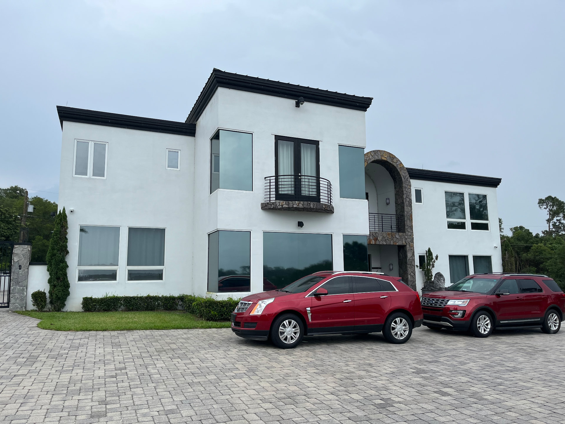 Modern white Florida home exterior with tinted windows