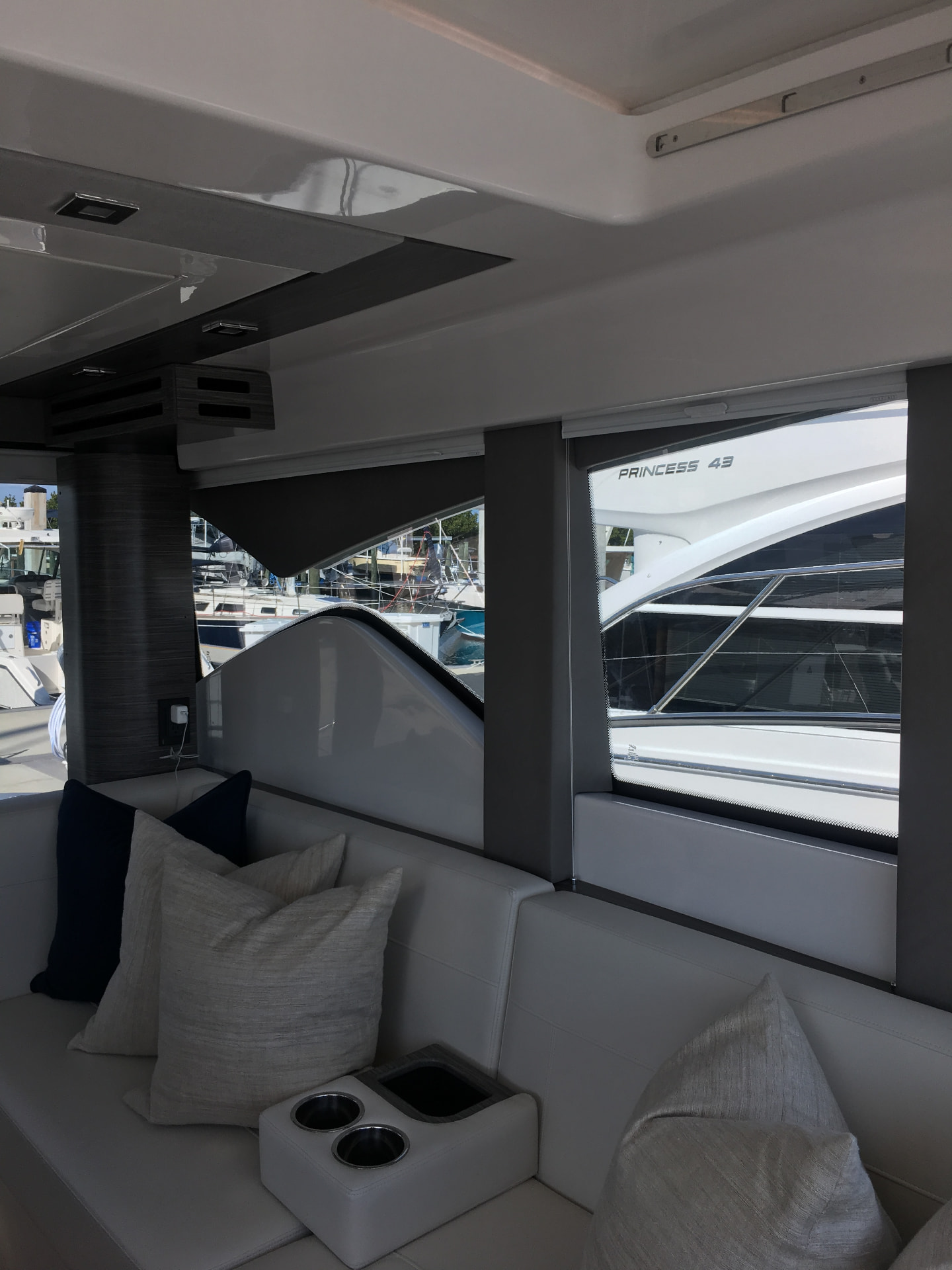 Yacht cabin lounge with tinted windows and marina views